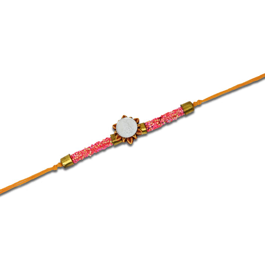 Boys' Rakhi featuring a silver Baal Gopal design with pink plastic flat circular beads.