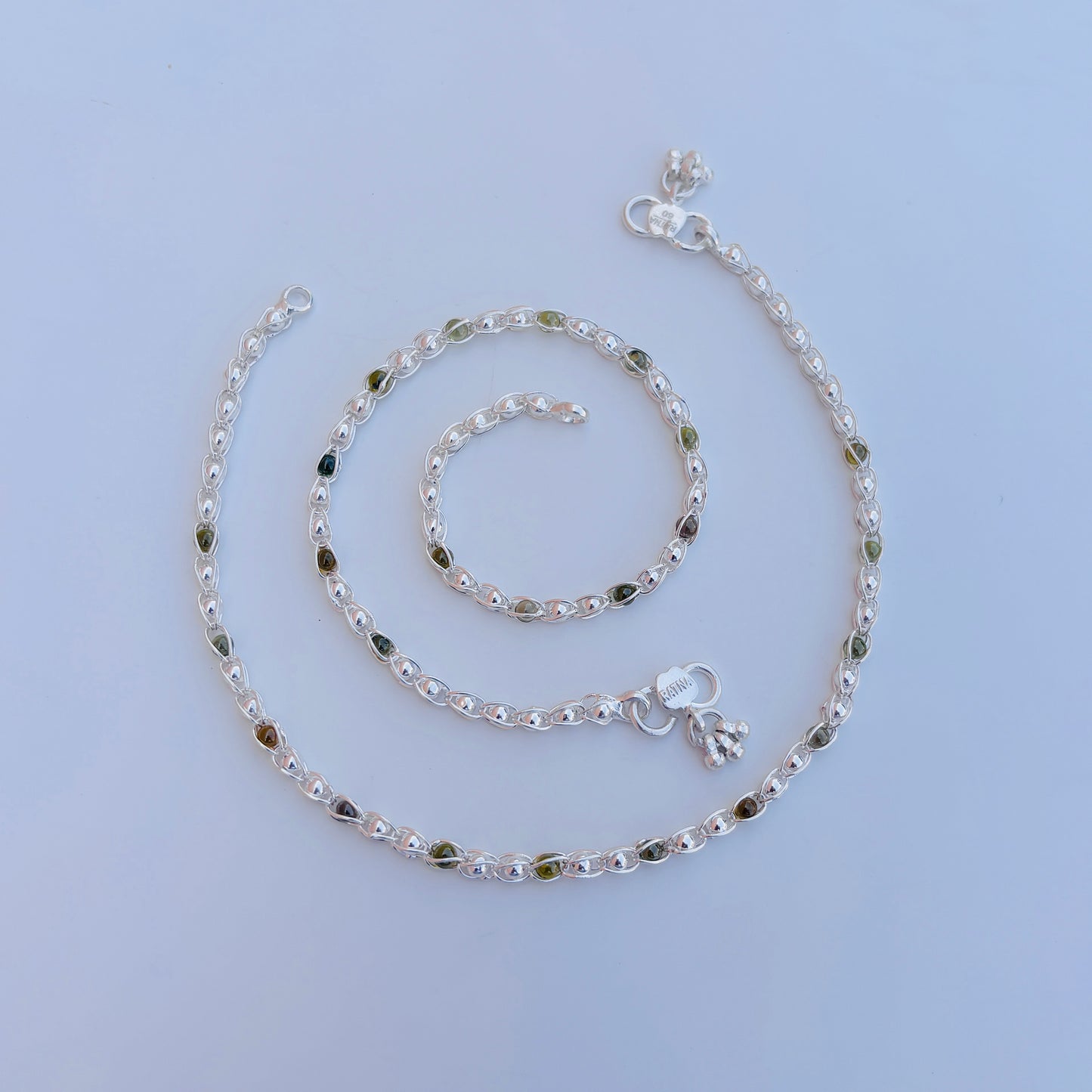 Beautiful silver payal with green and silver beads for a traditional touch