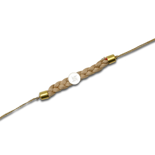 Boys' Rakhi featuring a silver Swastik centerpiece with a cream tangle Moli.