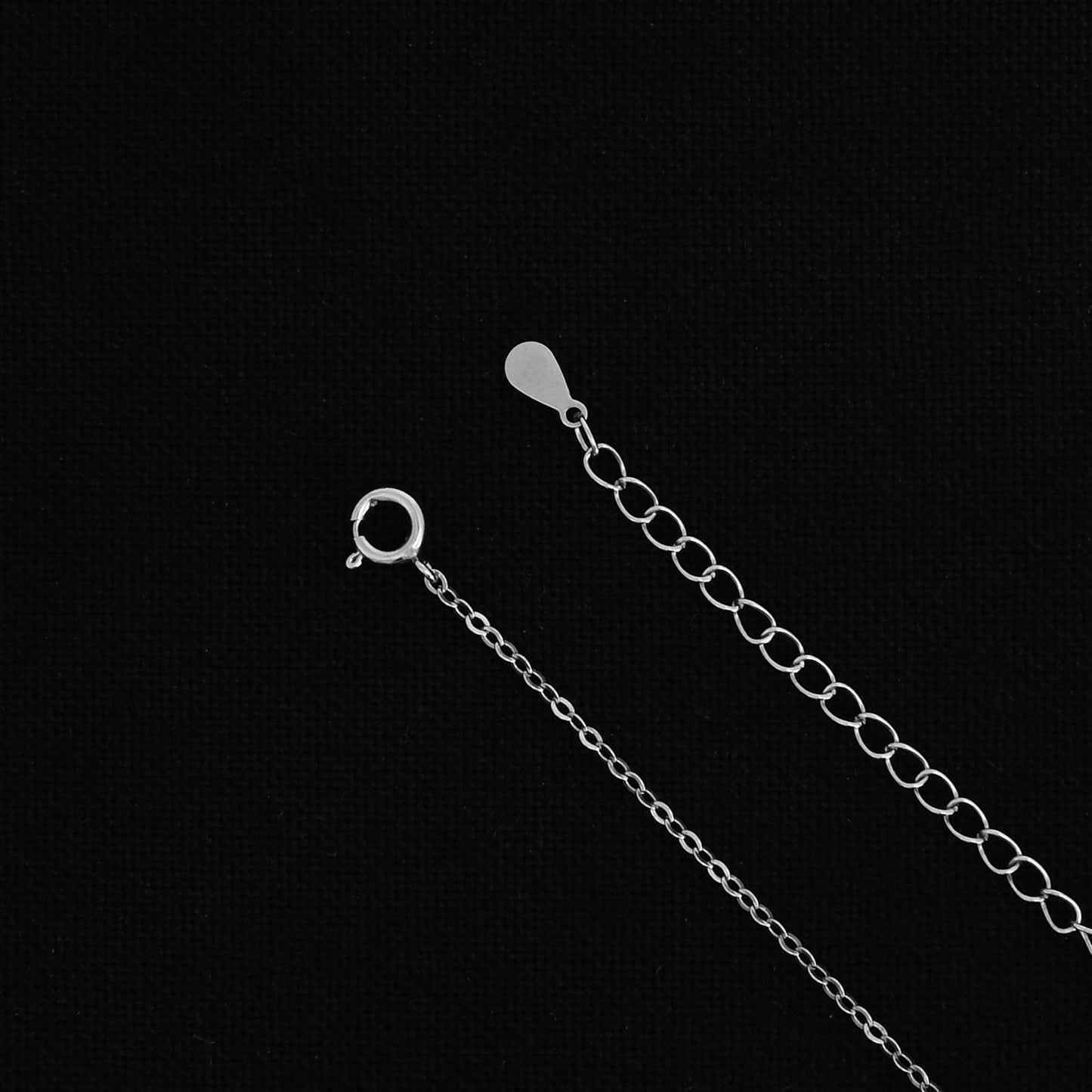 Silver chain with a custom 'H' symbol pendant design.