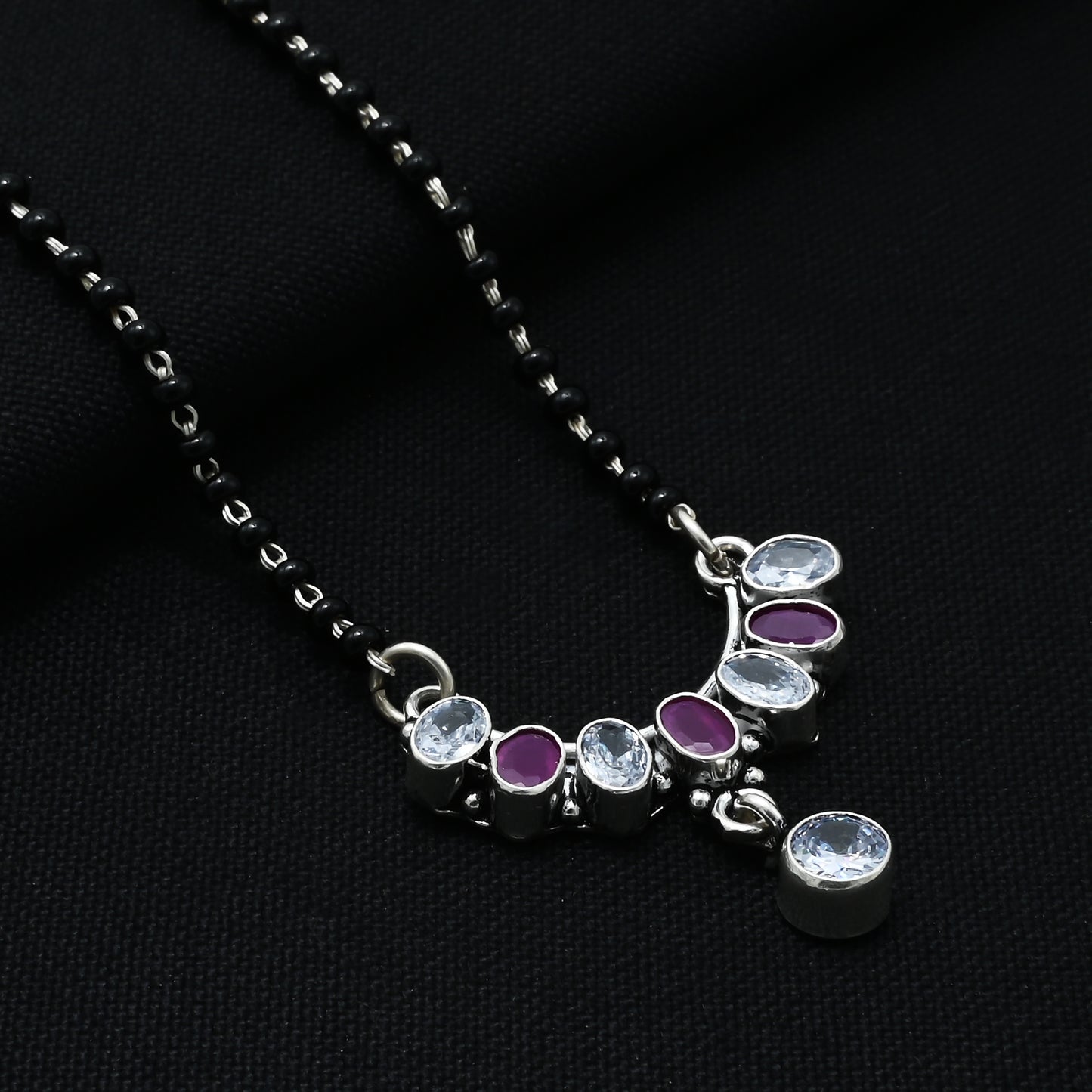 Sophisticated sterling silver mangalsutra adorned with a purple gemstone in a bow-shaped design