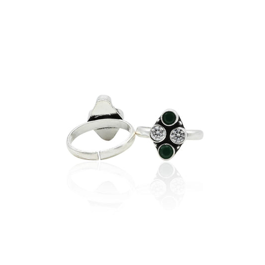 Charming silver toe ring adorned with white and green gems, perfect for a colorful touch