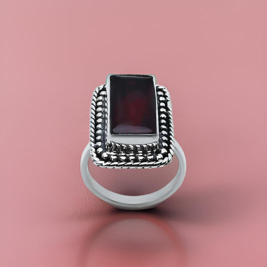 Elegant rectangular red gem ring in vintage silver.
