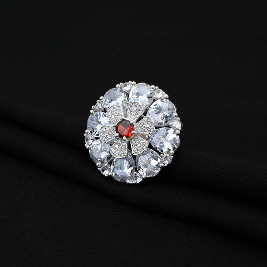 Cute silver ring with a red gemstone at the center of a lovely flower design for girls.
