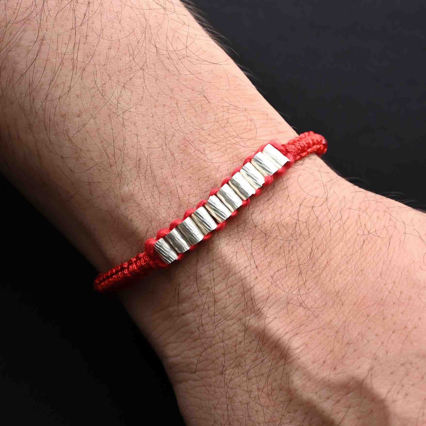 Elegant Rakhi with silver cylinder beads, ideal for boys