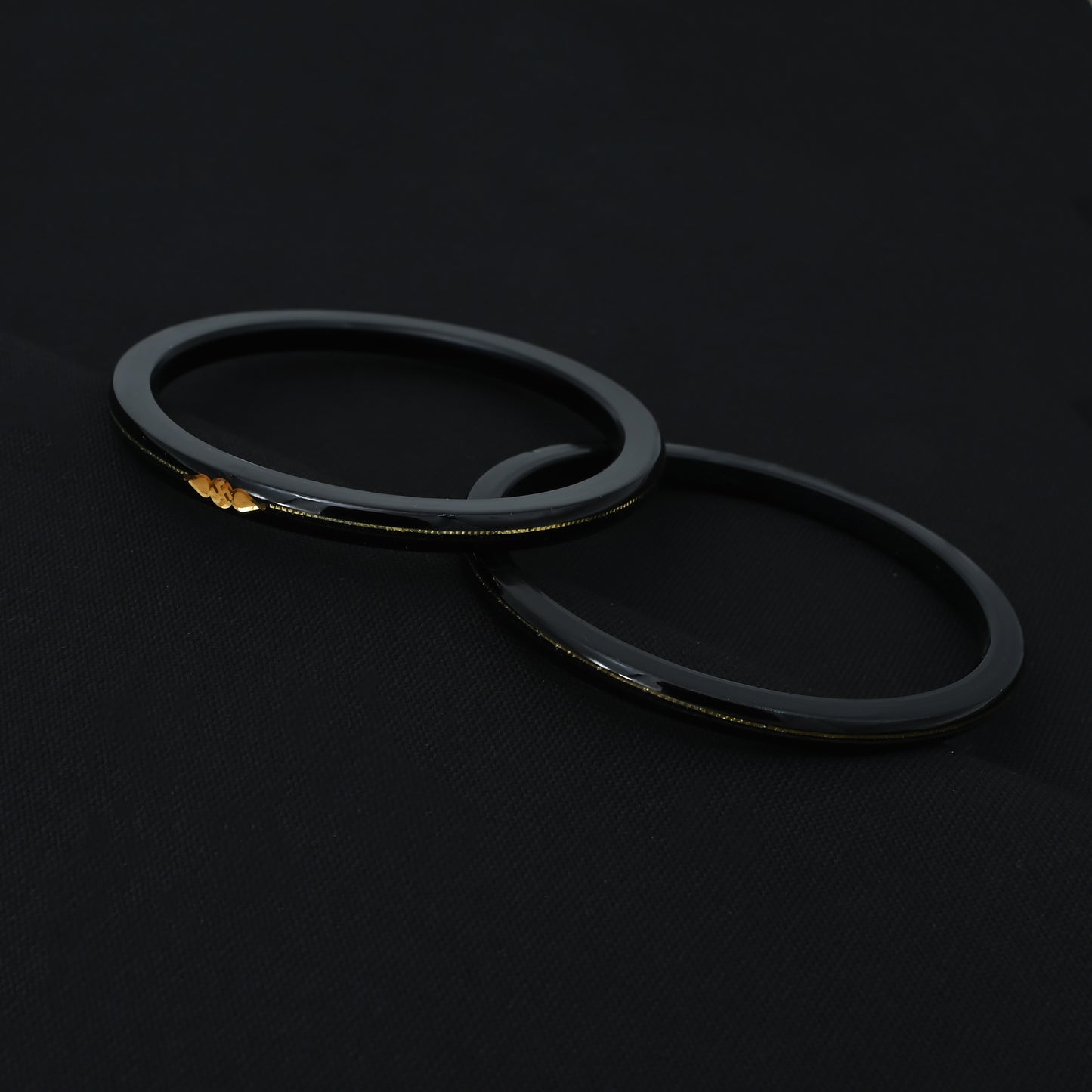 Silver Center Swathik Design Black Bangles