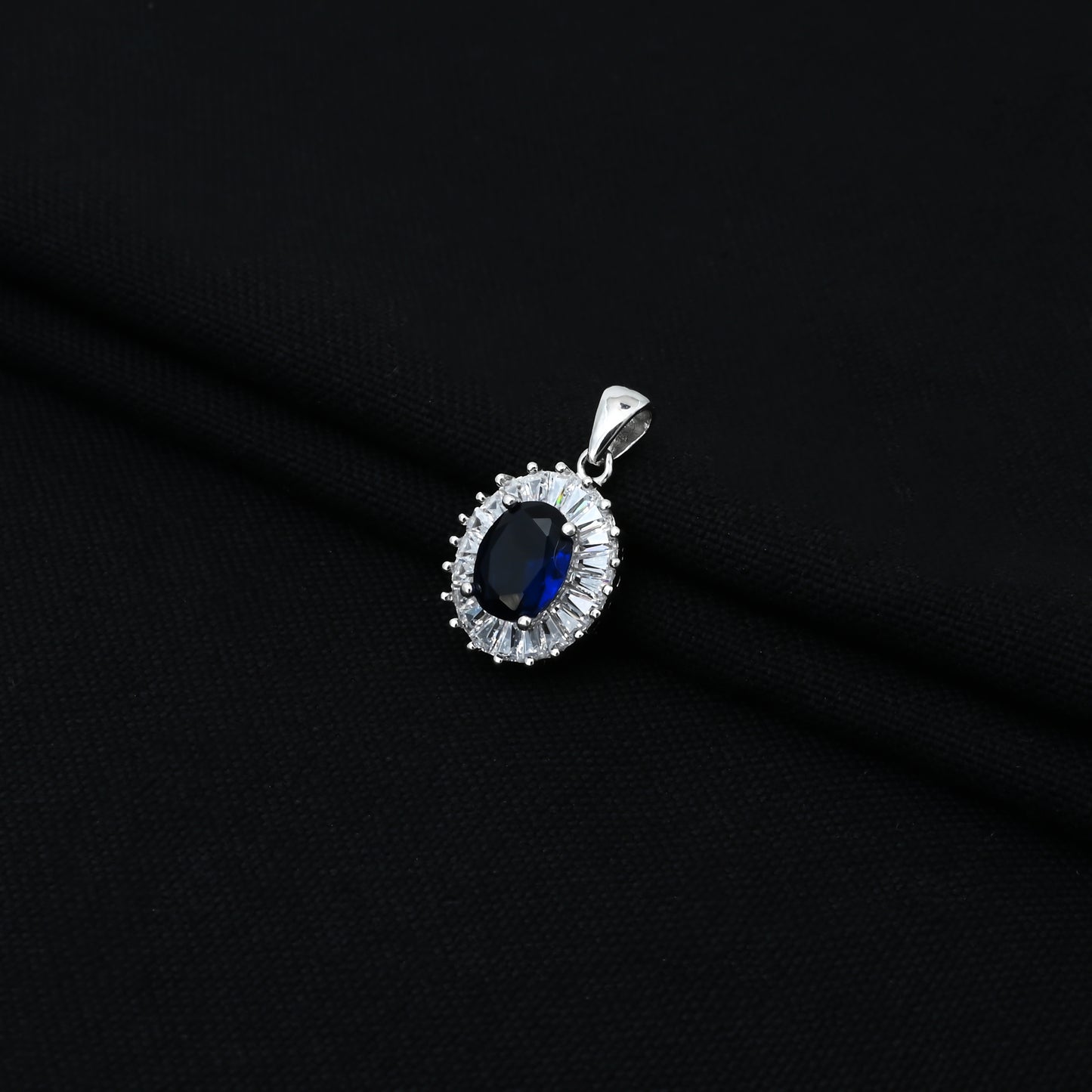 Stylish silver pendant for girls, featuring a blue oval gem with a CZ-studded border