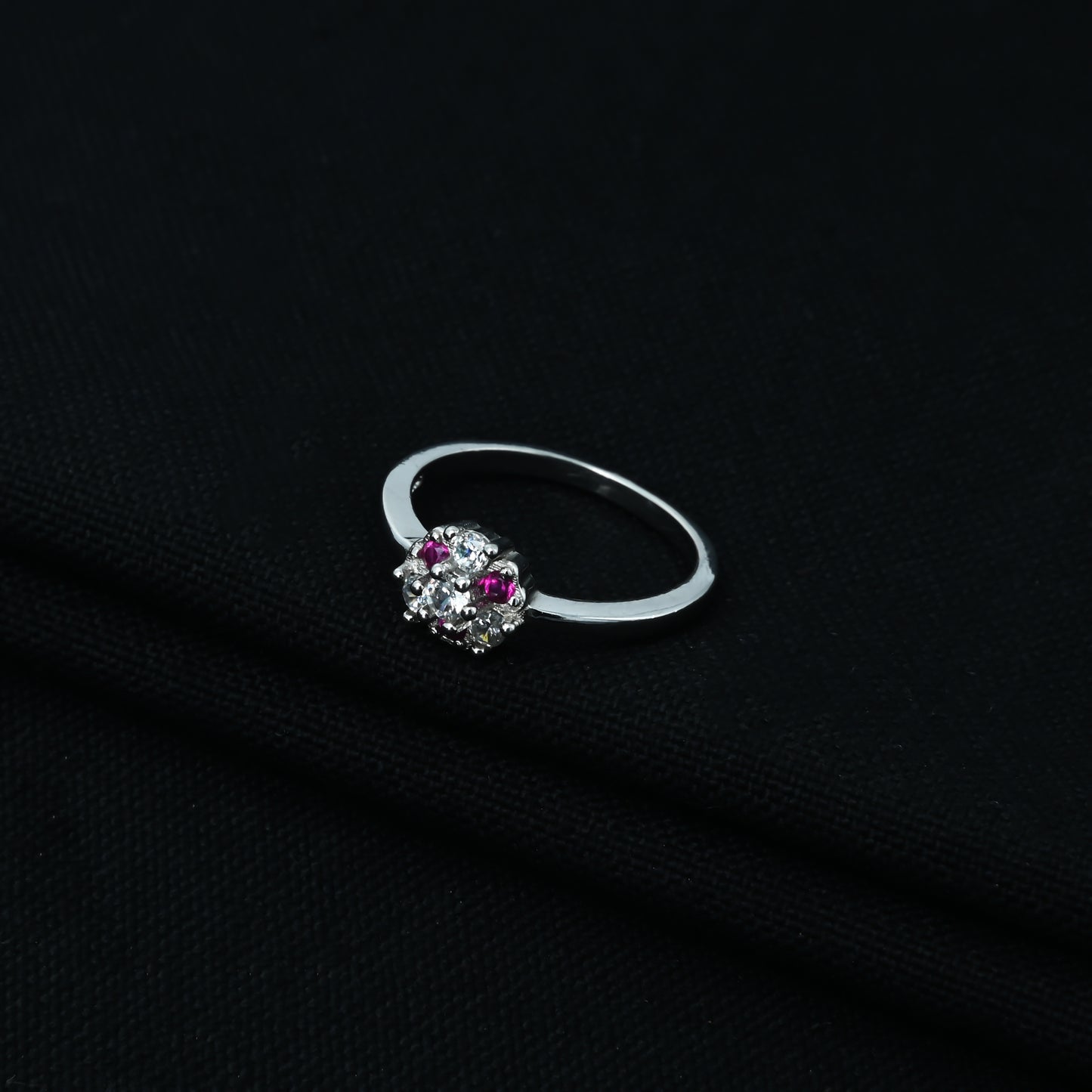 Chic designer silver ring adorned with purple and white stones.