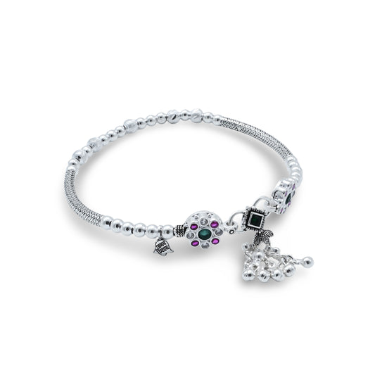 Elegant silver kada anklet featuring multiple stones and decorative ghungroos.