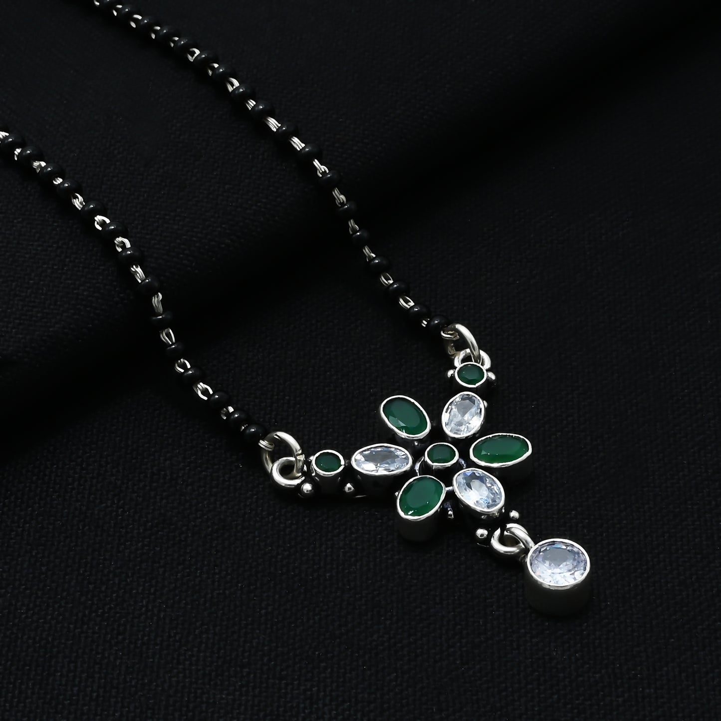 Chic sterling silver mangalsutra adorned with green round and oval gemstones for a striking look