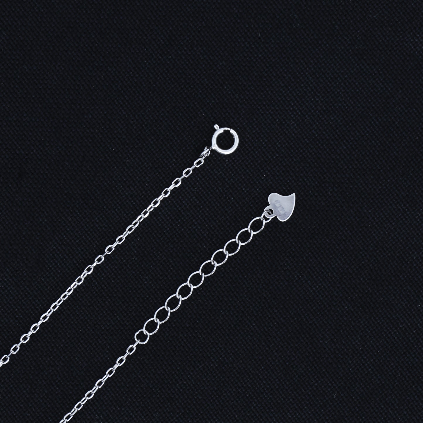 Stylish silver pendant showcasing a sleek black heart design