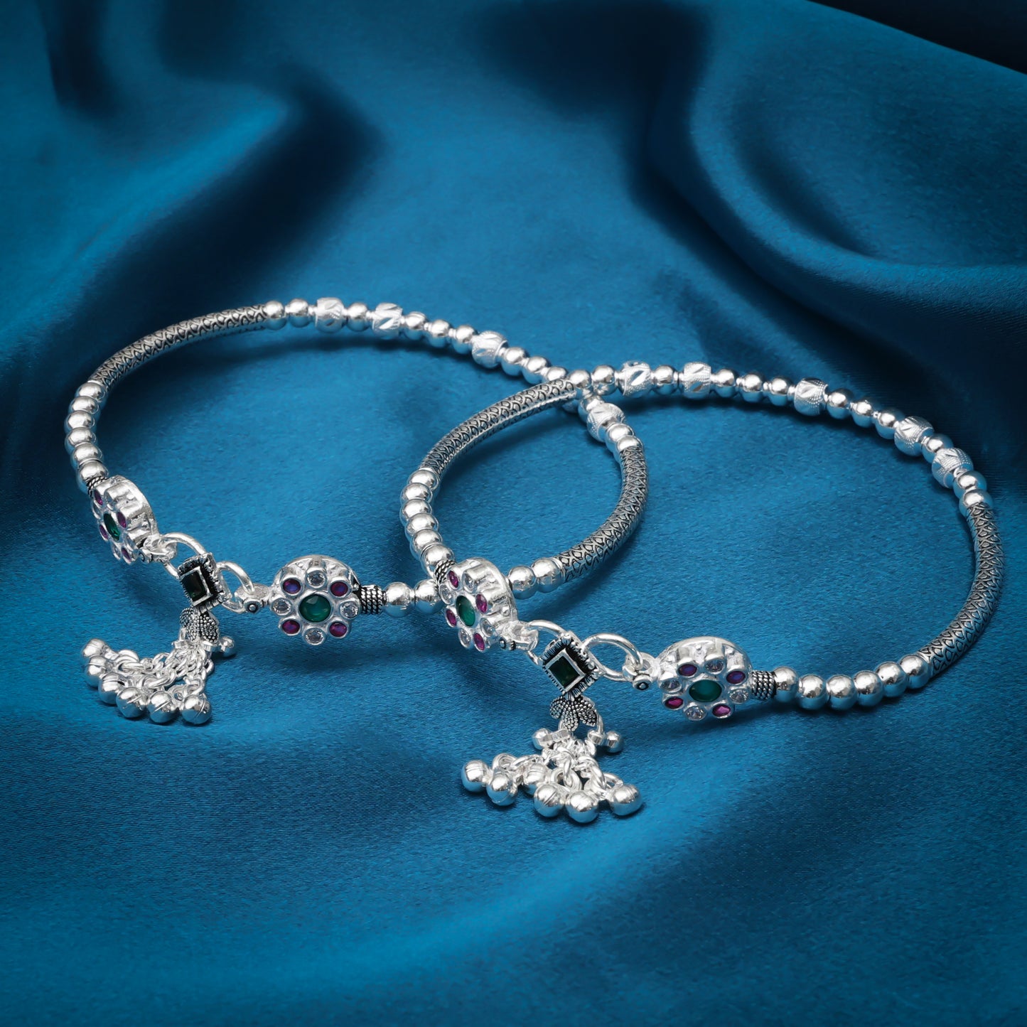 Multiple stone-studded sterling silver kada payal with ghungroo details.