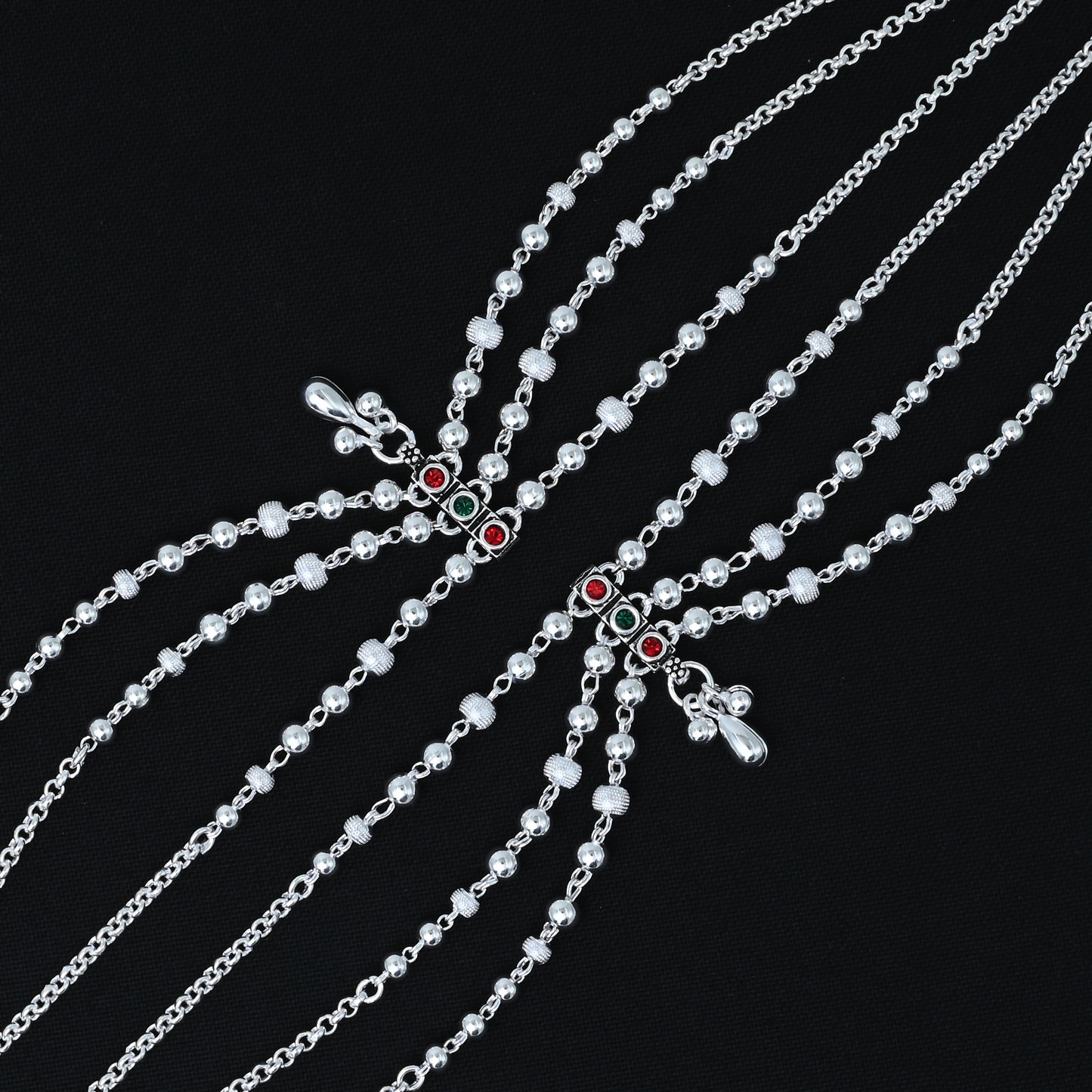 Charming silver payal with a mix of red and green gemstones and silver beads, designed for girls.