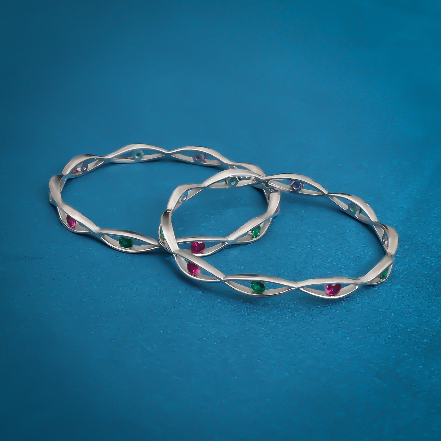 Charming silver bangles with multicolored pearls, adding a pop of color and elegance.