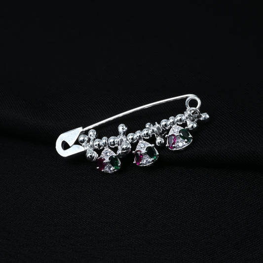 Elegant silver saree pin adorned with green and purple stone accents