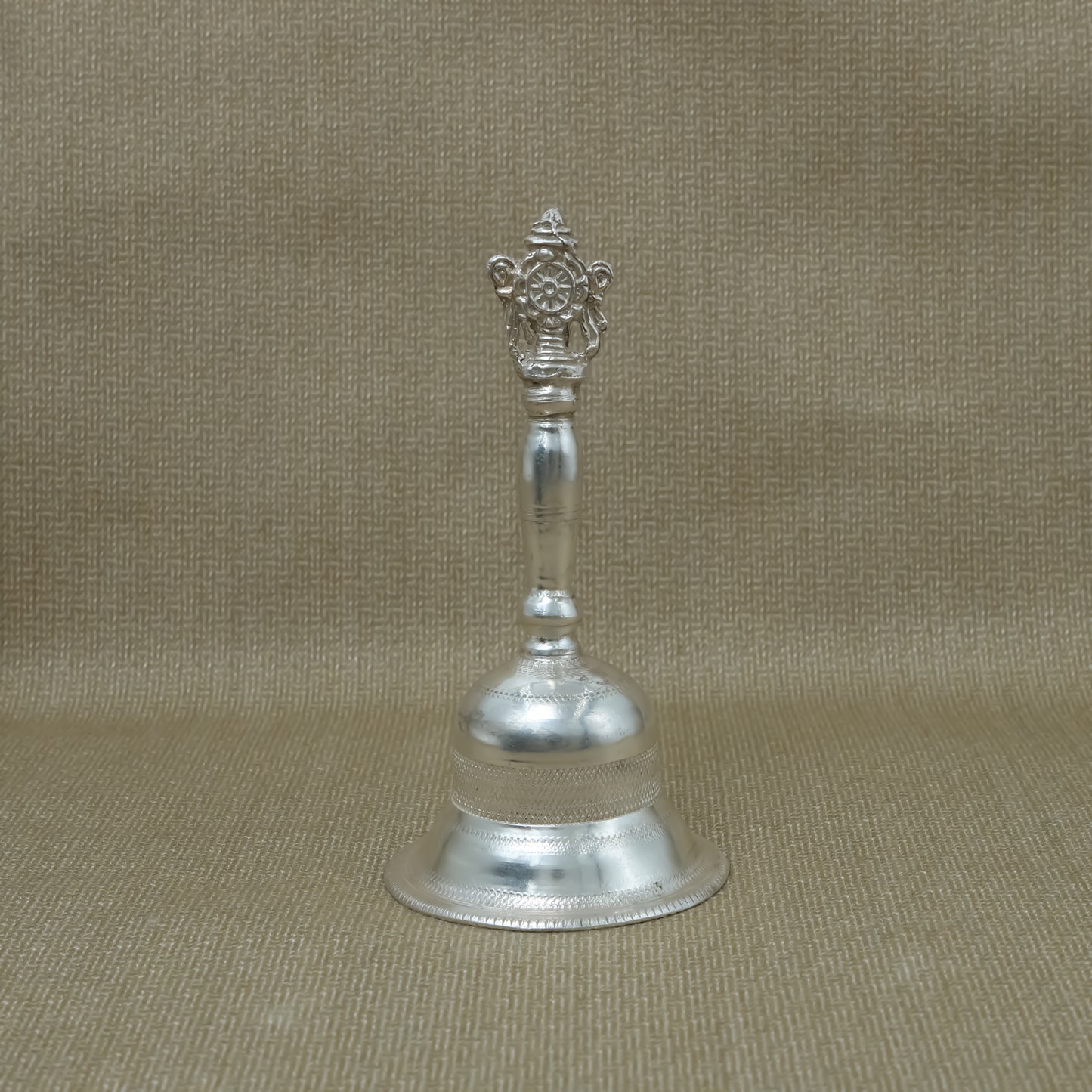 Elegant silver bell with detailed design, perfect for adding a sacred touch to your worship.