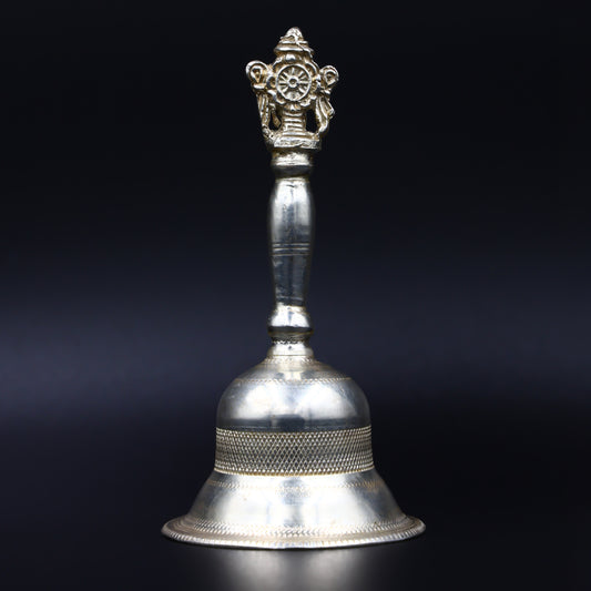 Close-up of the intricately crafted silver puja bell, ideal for enhancing temple or pooja ceremonies.