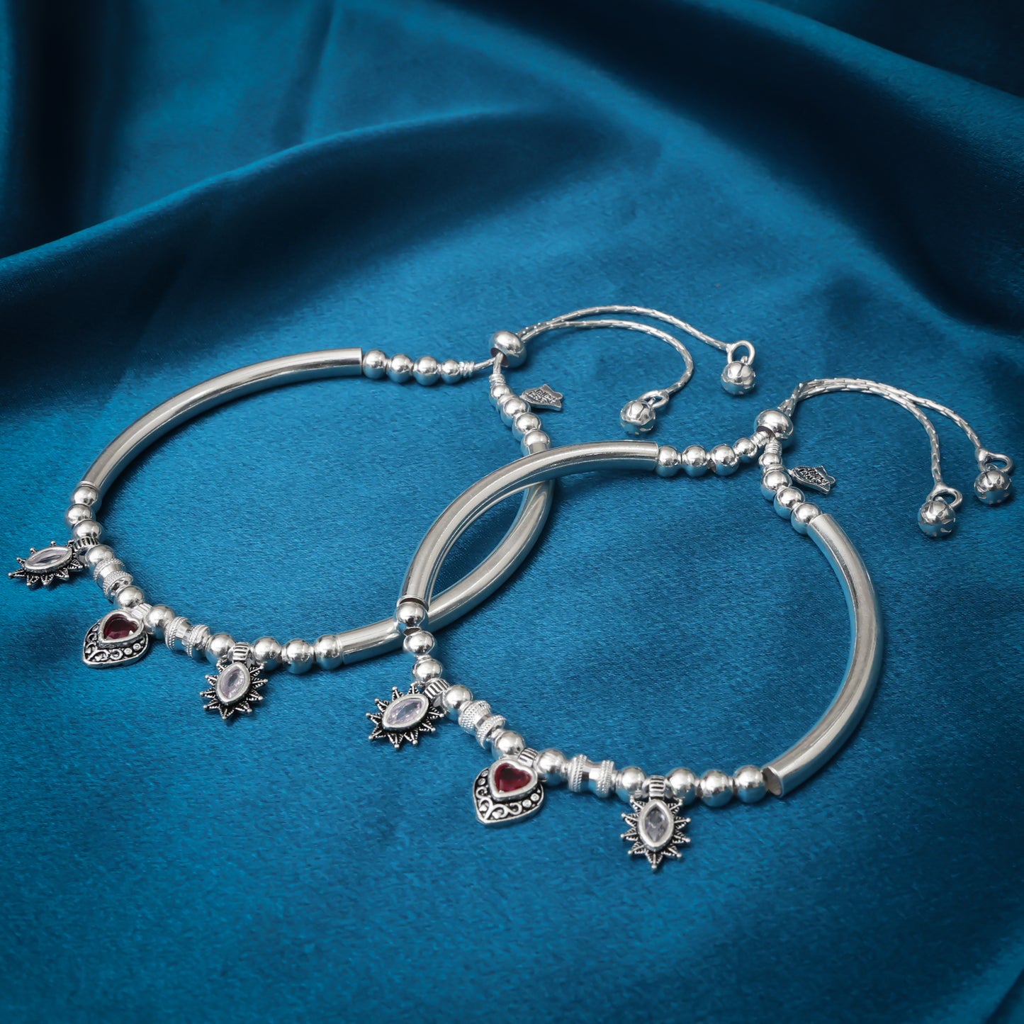 Charming silver kada payal adorned with a striking red heart-shaped stone.