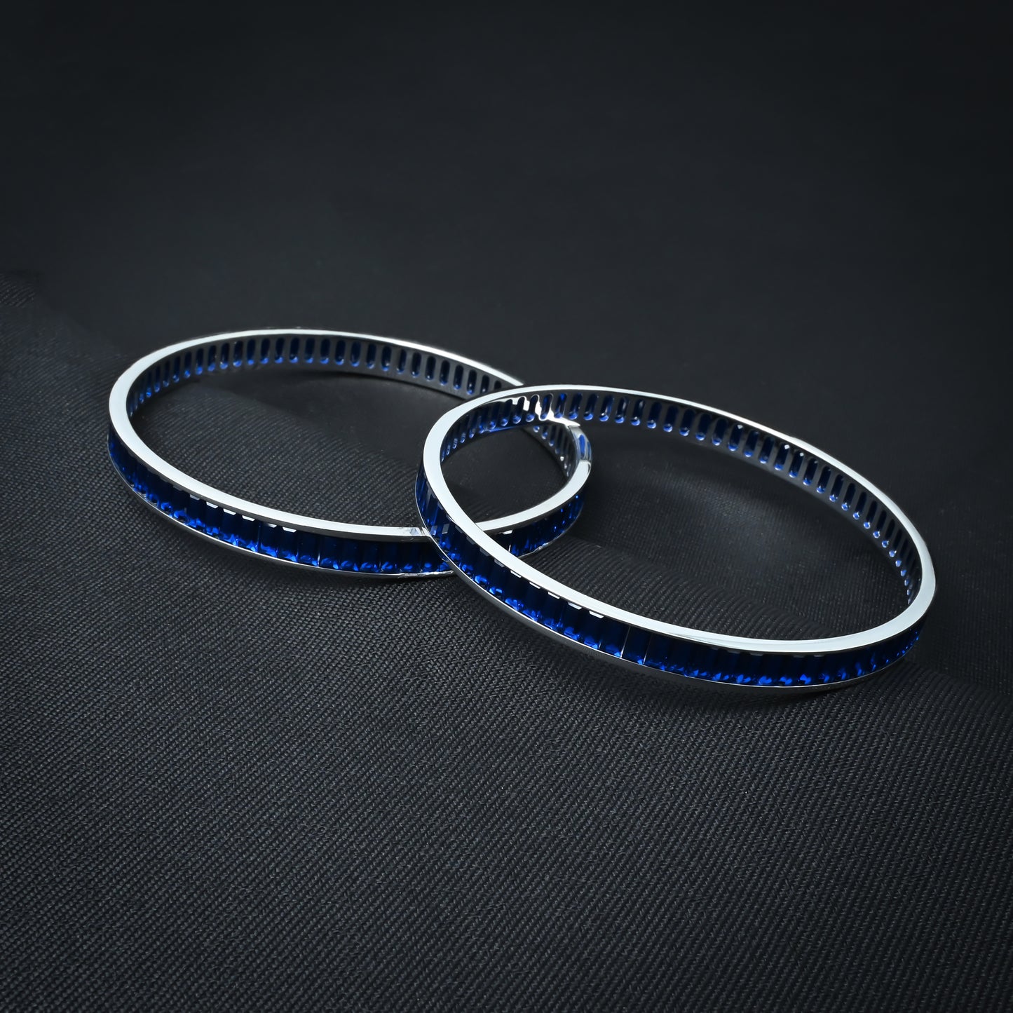 Charming silver bangles with vibrant royal blue stones