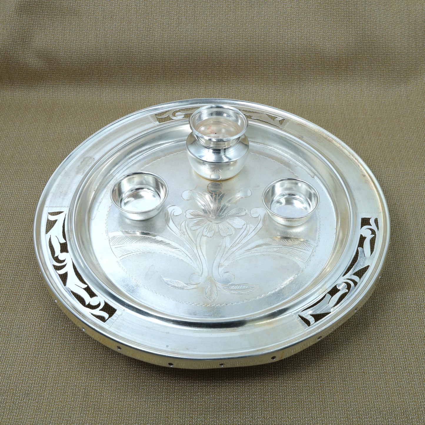 Elegant handmade silver pooja thali set, adding a sacred touch to your pooja offerings.