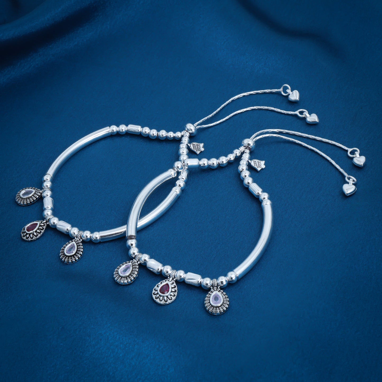 Charming beaded anklet featuring vibrant purple and white gemstones on a silver chain