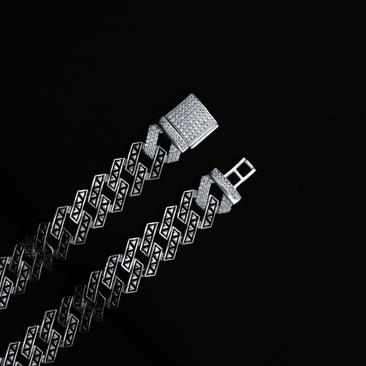 Men's modern silver Cuban chain with angular design.