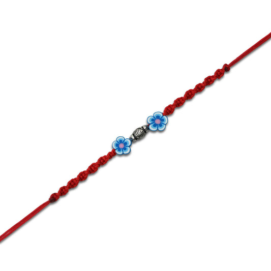 Sterling silver Rakhi featuring a blue flower design, perfect for boys