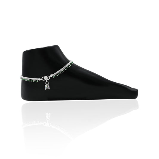 Charming silver anklet with beautiful green gems, perfect for a subtle and sophisticated touch