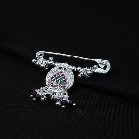 Elegant silver saree pin featuring a heart design with purple and green stone accents