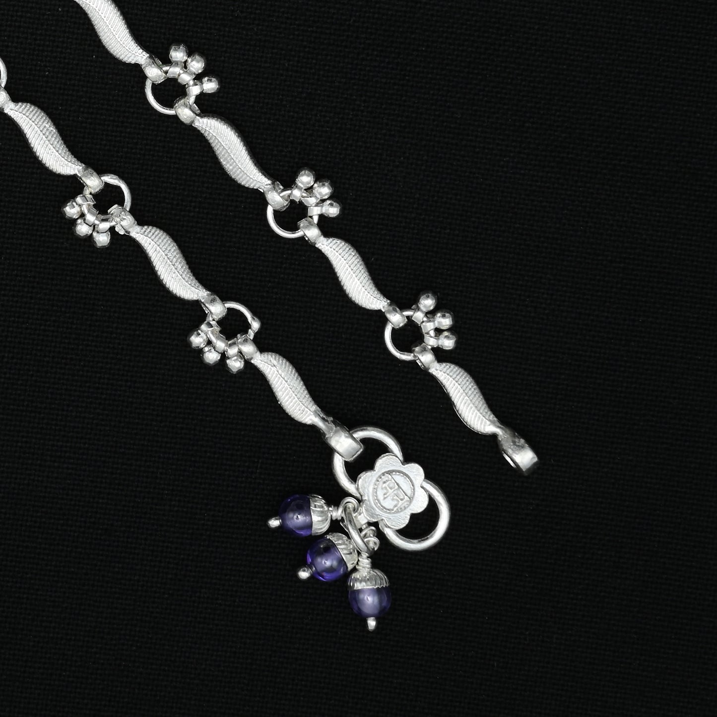 Silver anklet with spinning bead accents for a fashionable and eye-catching style