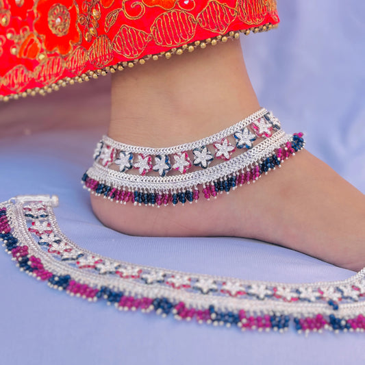 Charming silver payal with intricate purple and blue flower patterns, adorned with vibrant beads