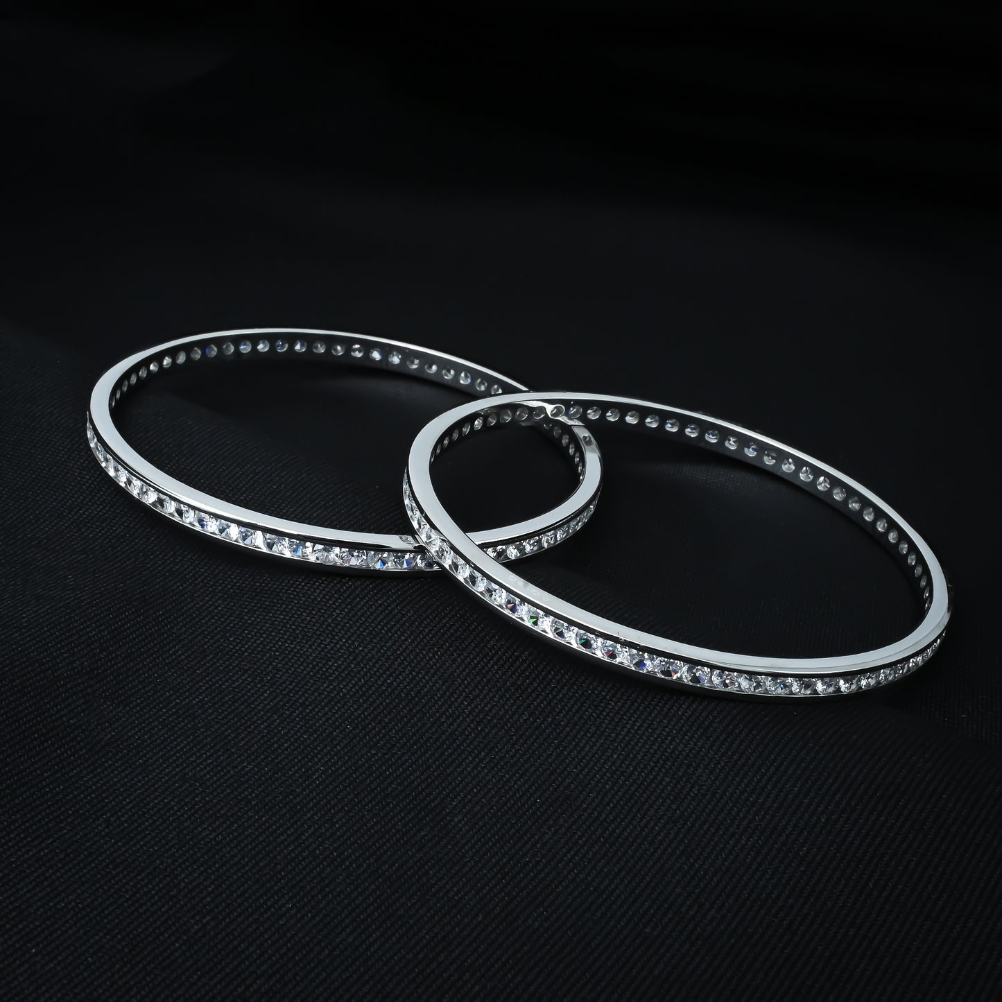 Stylish silver bangles embellished with multiple white stone accents