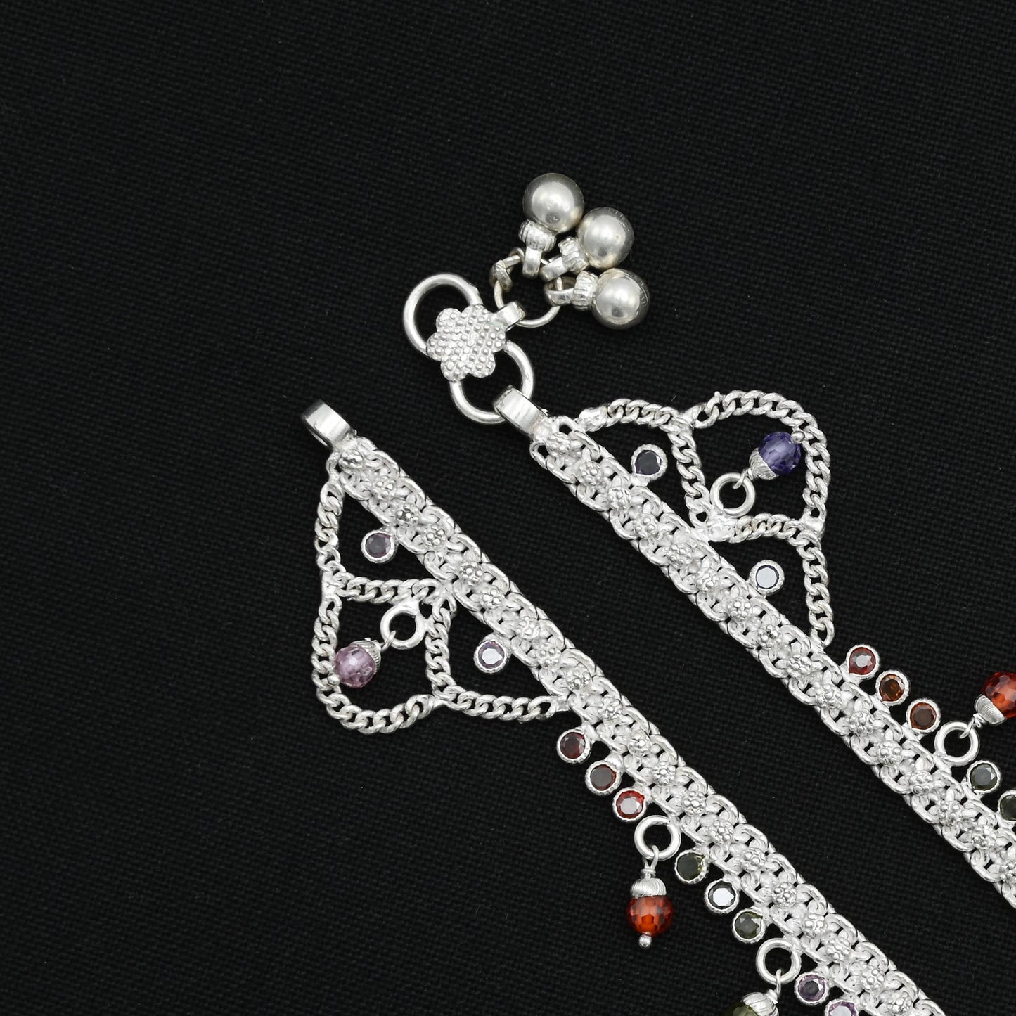 Silver anklet embellished with colorful beads, perfect for a chic finish