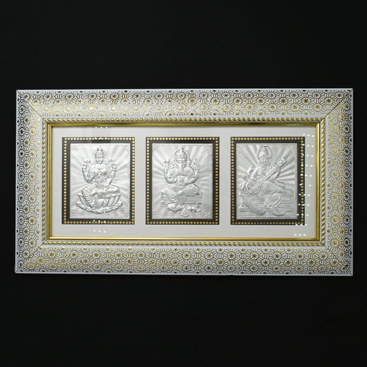 Beautiful pure silver frame with intricate Laxmi, Ganesh, and Saraswati designs, ideal for pooja spaces
