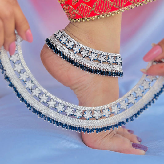 Blue stone flower design on silver payal.