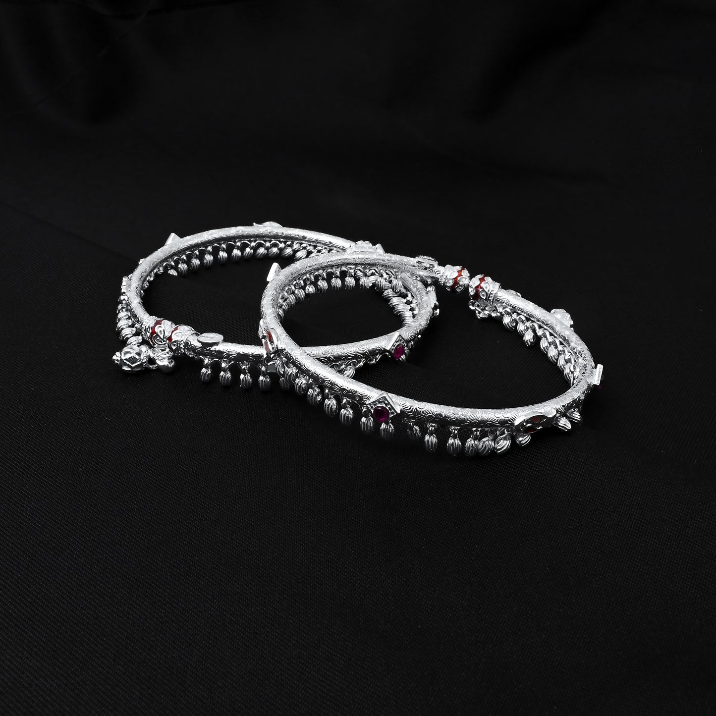 Silver kada payal with a chic design and red and blue stones