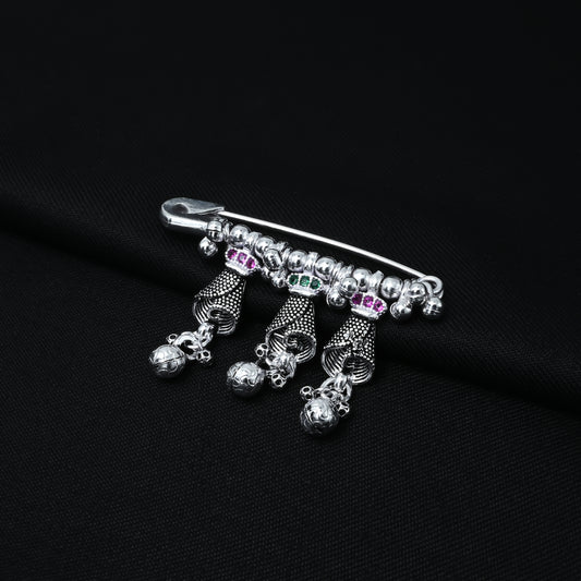 Elegant silver saree pin featuring silver beads and purple-green stones