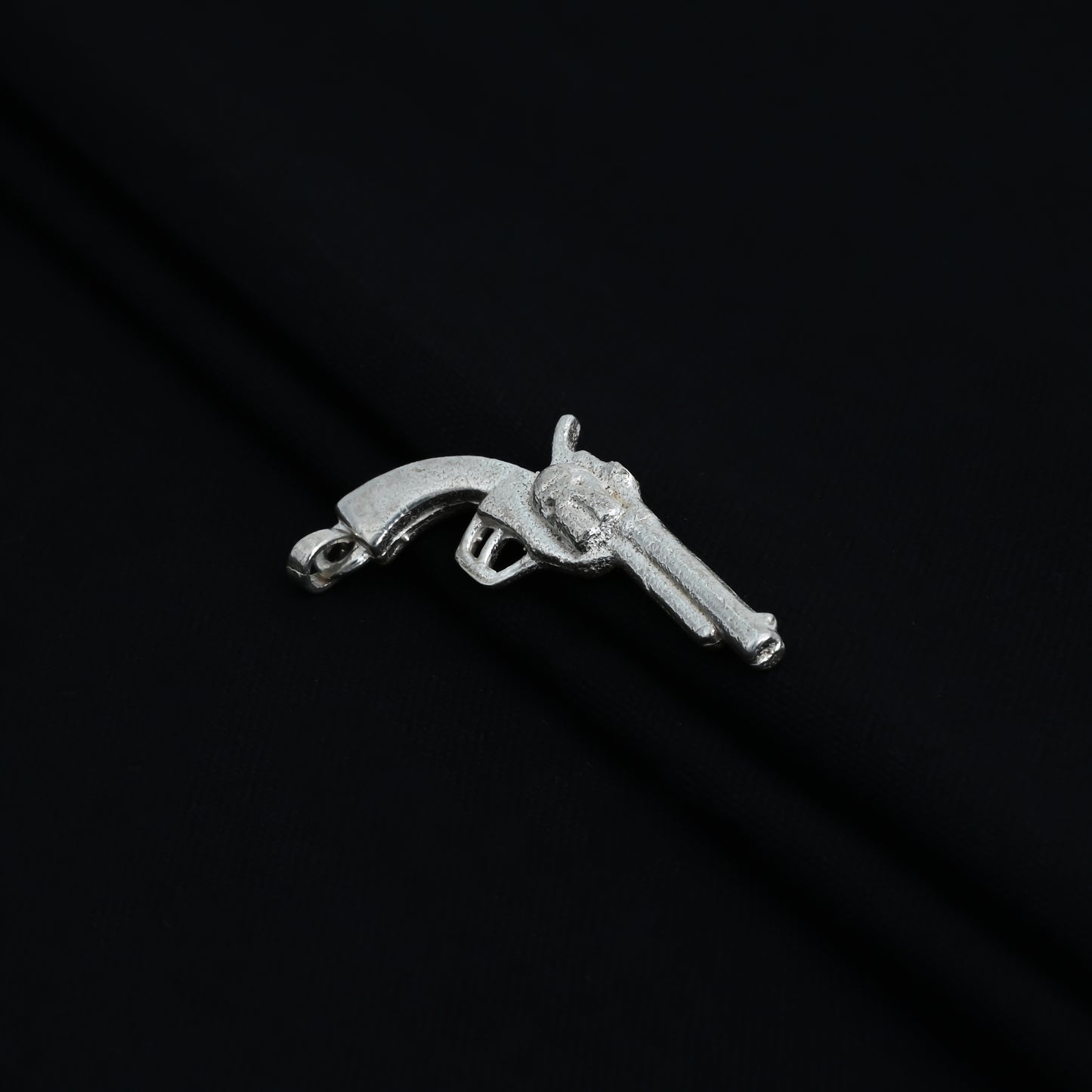 Charming silver pendant designed as a gun, perfect for boys