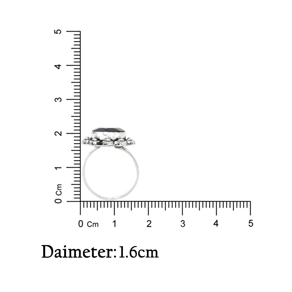 Silver ring with a bold black stone framed by a shasy border