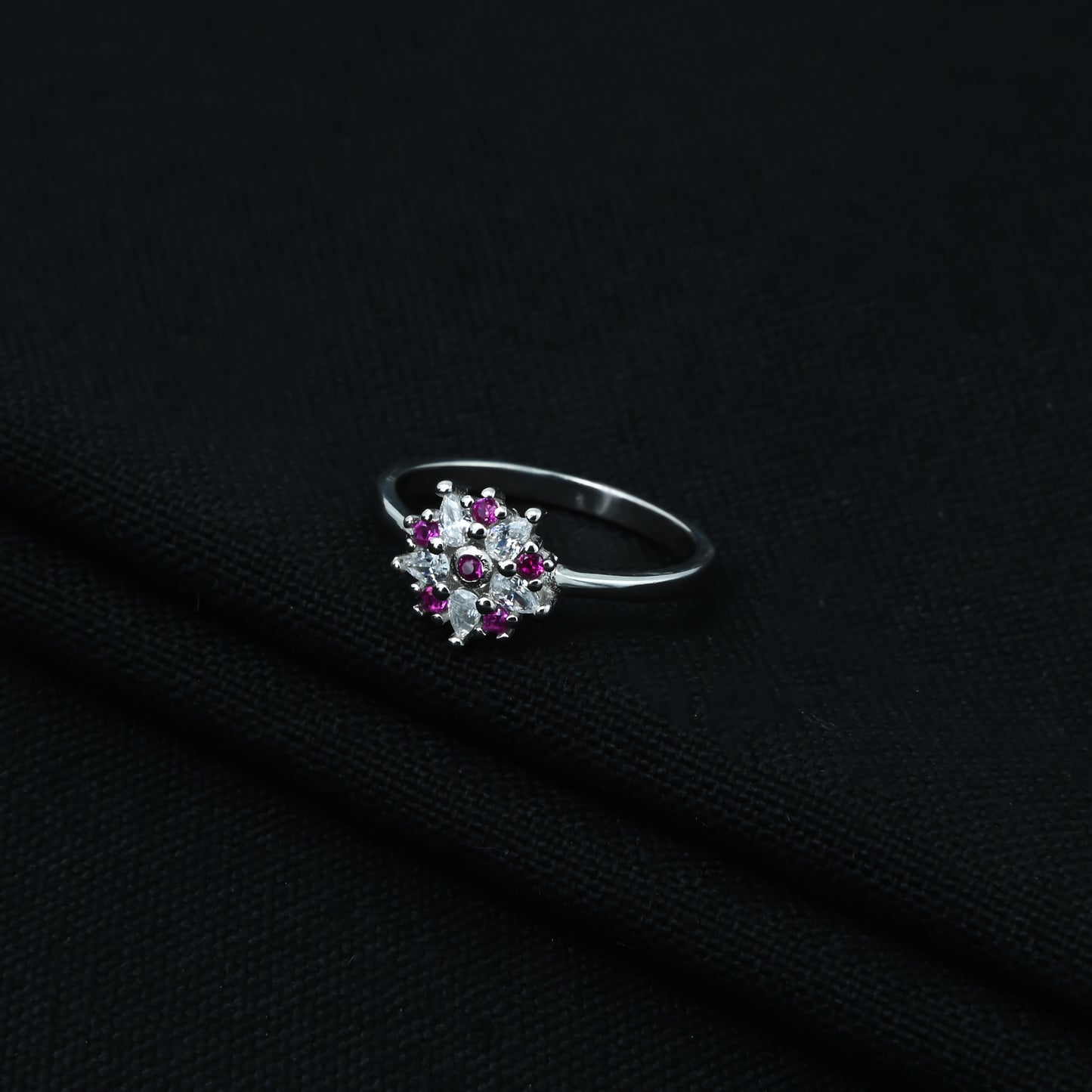 Sophisticated sterling silver floral ring adorned with purple and white stones.