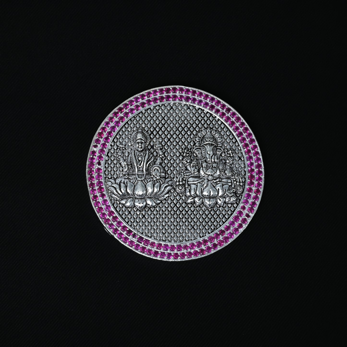 Elegant silver coin showcasing Lakshmi-Ganesha and a stone border