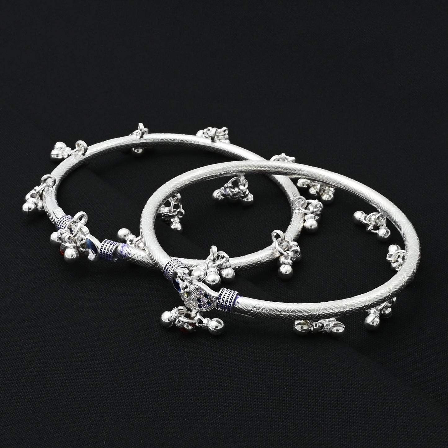 Charming silver kada payal adorned with the peacock symbol, representing tradition.