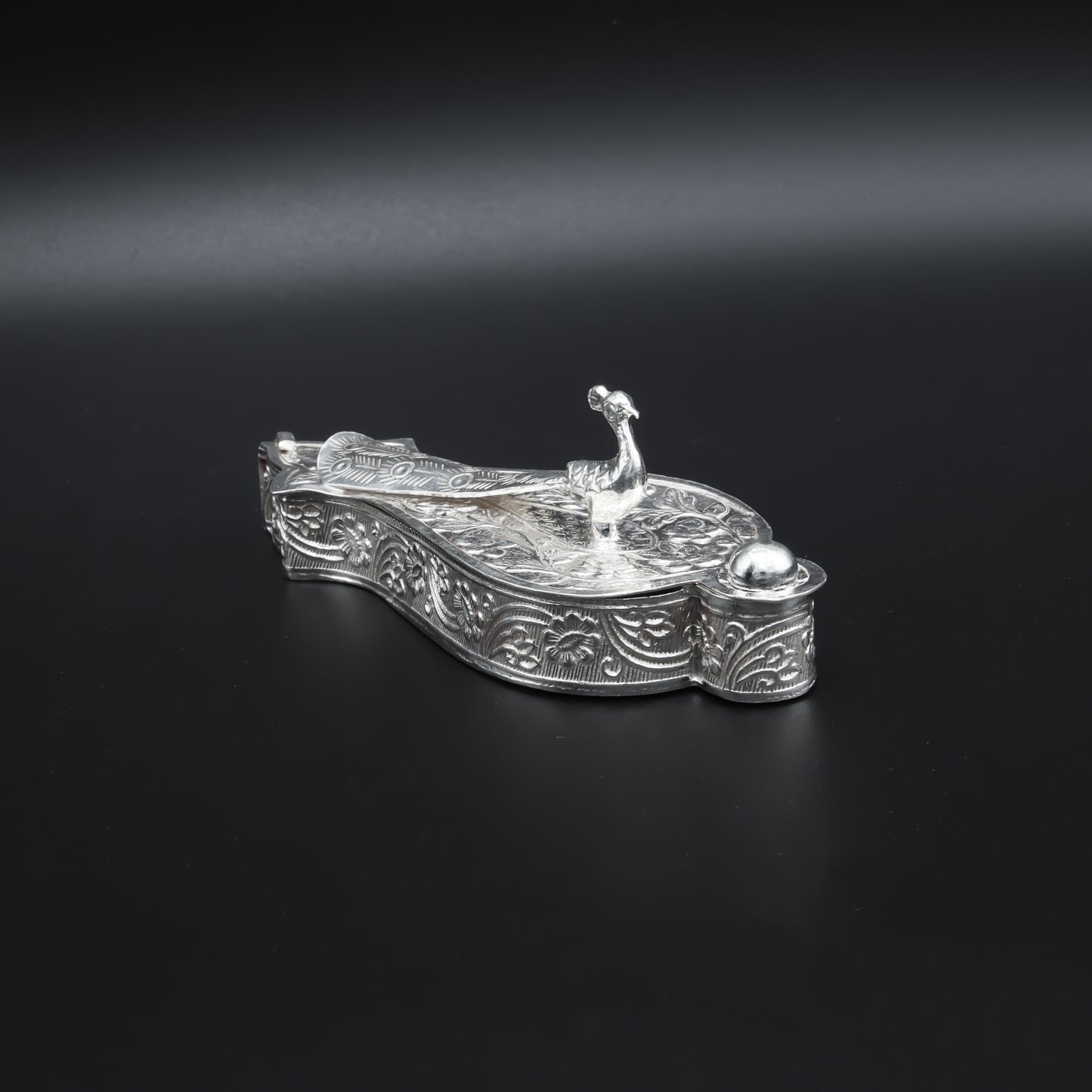 Traditional silver Sindoor box adorned with a beautiful peacock pattern