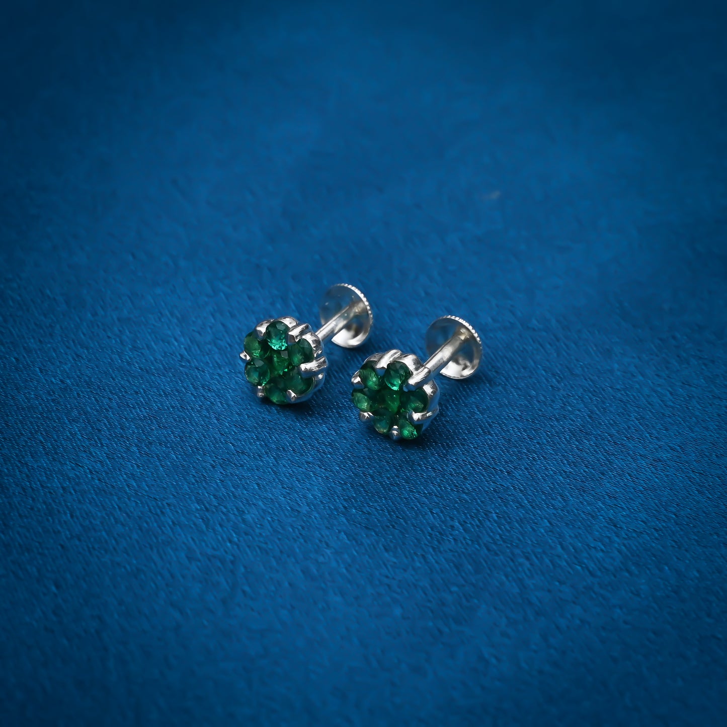 Simple silver stud earrings with bright green stones