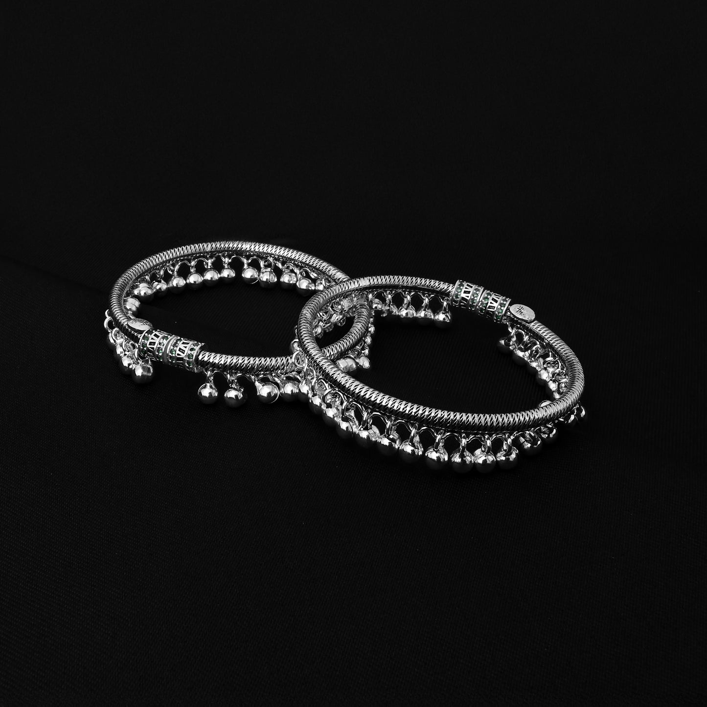 Elegant oxidised silver kada payal adorned with green stones and ghungroo