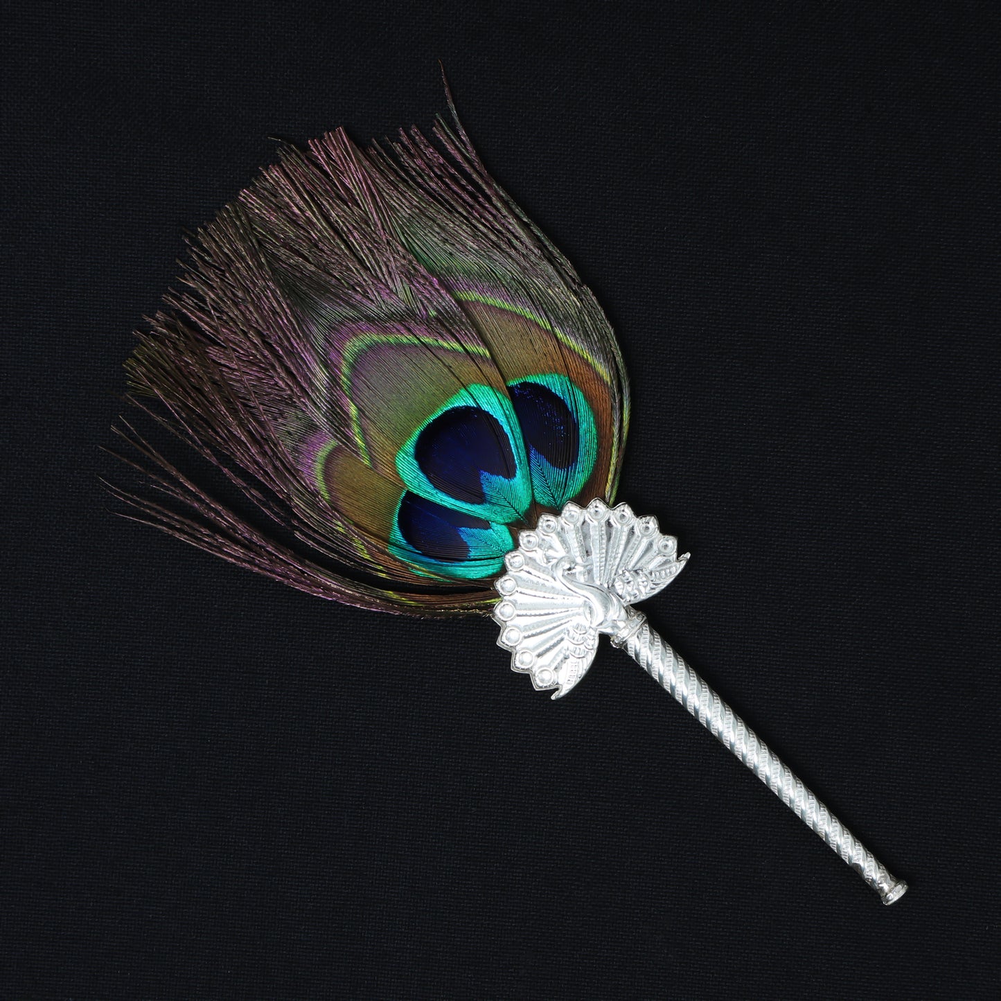 Exquisite peacock feather fan with detailed silver handle, ideal for Laddu Gopal pooja ceremonies.