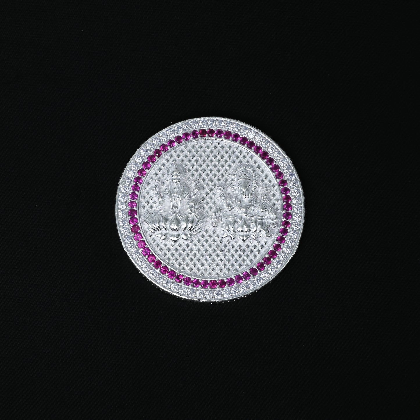 Silver coin depicting Lakshmi and Ganesha, embellished with purple and white stones