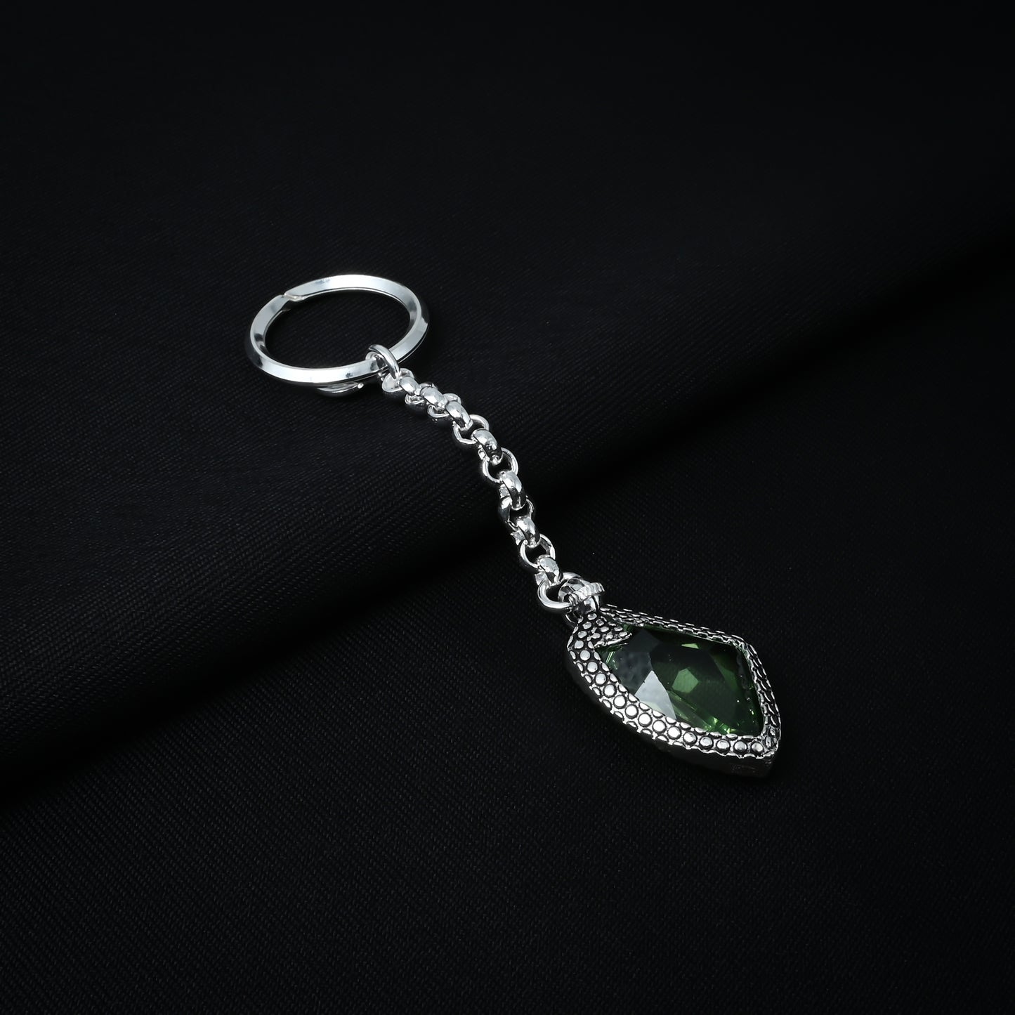 Trendy silver chain keychain adorned with a sparkling green gemstone for a unique look