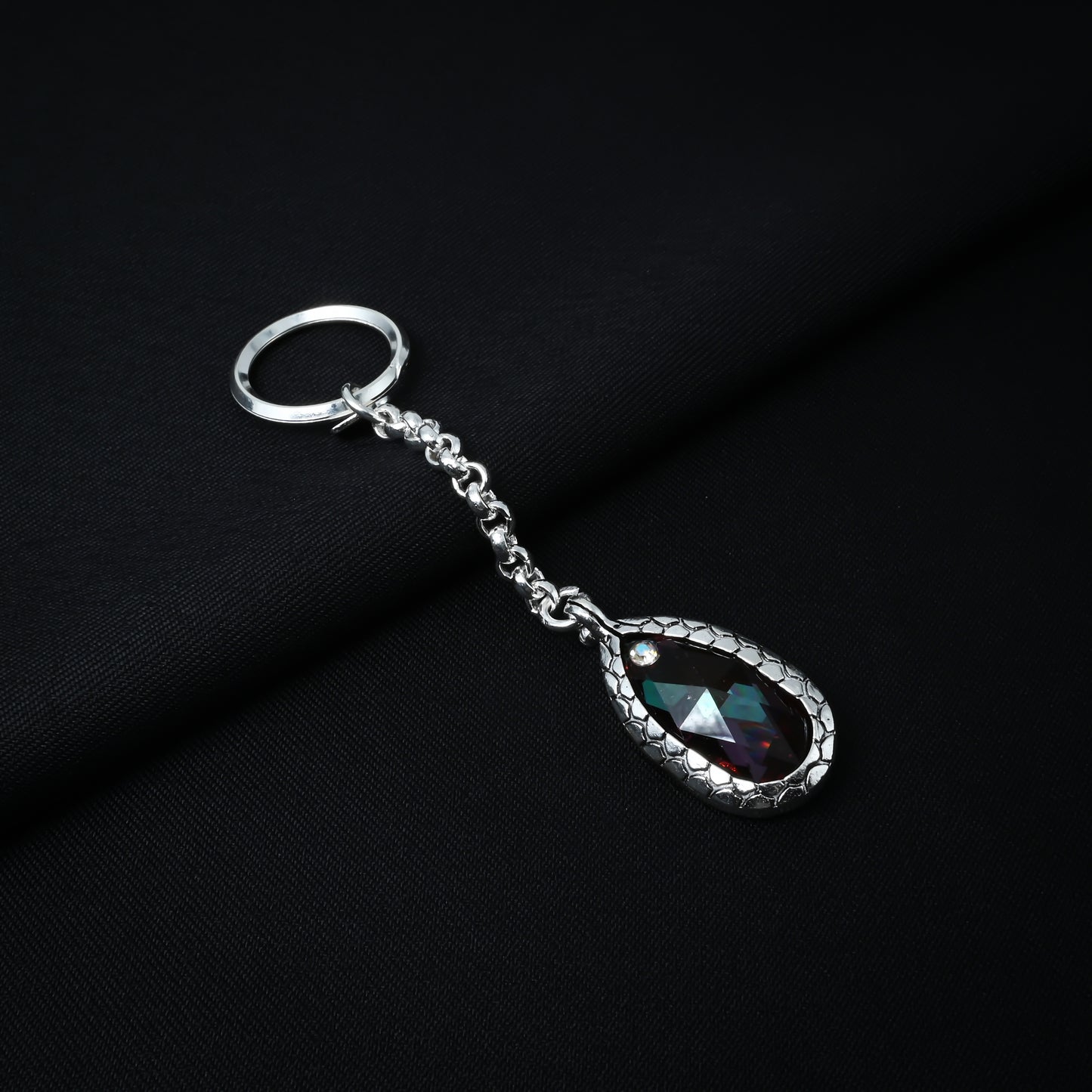 Fashionable silver chain keychain with a bright orange gemstone for a pop of color