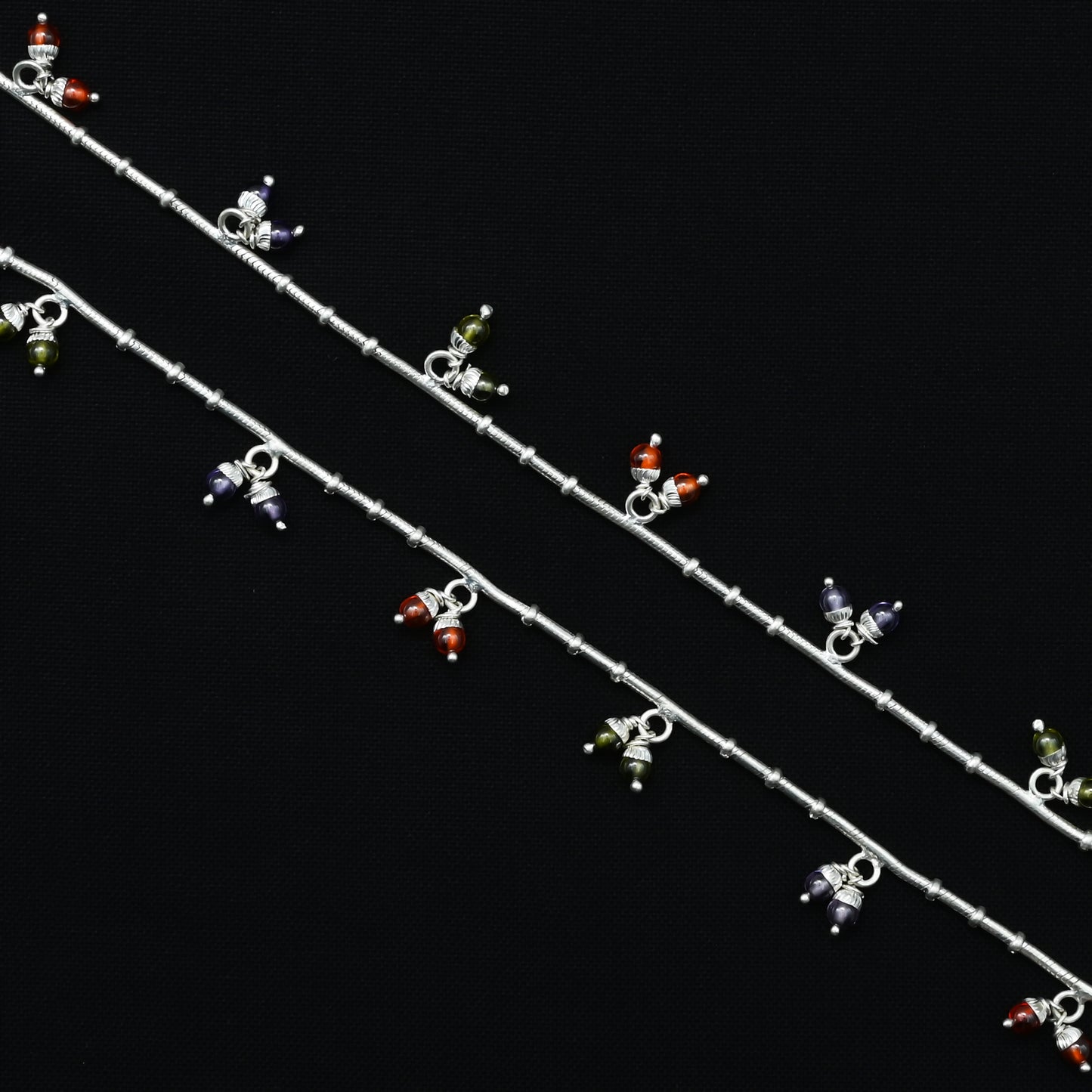 Simple silver payal with a delicate arrangement of multicolored gemstones for everyday elegance